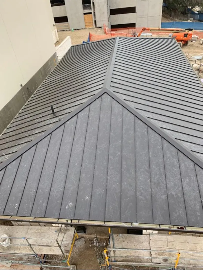 Commercial metal roof construction with crane equipment in American Canyon